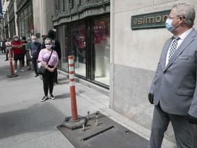 Simons manager Jean Francois Godbout looks over lanes at the entrance of the downtown store on Monday May 25, 2020.