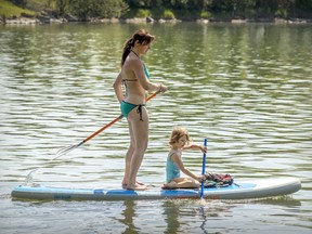 Sandra Pehar brought daughter Xenia from their home in the Rosemont-La Petite-Patrie borough to stand-up paddle in the water off LaSalle on a warm, humid Tuesday May 26, 2020.