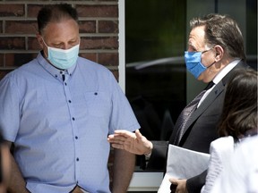 François Legault speaks with Stéphane Cormier of Fédération Interprofessionnelle de la santé du Québec as the premier arrives in Joliette on Friday, May 29, 2020.