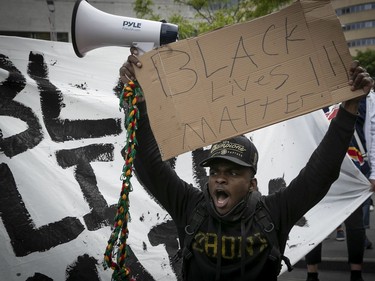 MONTREAL, QUE.: MAY 31, 2020 --  Protester holds up sign during anti-racist and anti-police brutality demonstration on Sunday May 31, 2020. Most protesters are wearing mask for the COVID-19 pandemic (Pierre Obendrauf / MONTREAL GAZETTE) ORG XMIT: 64505- 8323