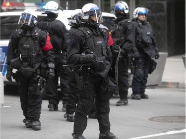 Montreal police riot squad stand on the corner of Ste-Catherine and Stanley Sts. during an anti-racist and anti-police brutality demonstration on Sunday, May 31, 2020, in Montreal.