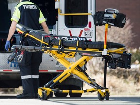 A paramedic returns a stretcher to his ambulance at Toronto Western Hospital during the ongoing Covid 19 pandemic, Wednesday April 1, 2020.