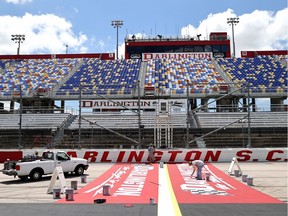 Track workers paint logos on the front stretch a day prior to the NASCAR Cup Series The Real Heroes 400 at Darlington Raceway on Sunday, May 16, 2020, in Darlington, S.C.