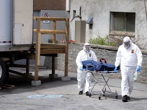 Funeral home staff transfer a body from a temporary morgue at Lakeshore General Hospital as the city deals with the coronavirus pandemic in Montreal, on Friday, May 1, 2020. (Allen McInnis / MONTREAL GAZETTE) ORG XMIT: 64331