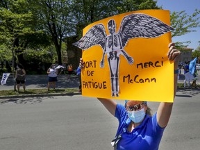 ICU nurse Maryse Tremblay holds up a sign during a demonstration by health-care workers outside Maisonneuve-Rosemont Hospital in Montreal Wednesday May 27, 2020.