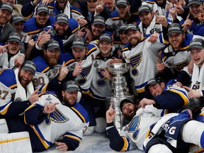 St. Louis Blues players pose for a team photo with the Stanley Cup after defeating the Boston Bruins in game seven of the 2019 Stanley Cup Final at TD Garden.