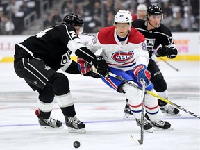 Ales Hemsky #83 of the Montreal Canadiens attempts to poke the puck around Derek Forbort #24 of the Los Angeles Kings during the first period at Staples Center on October 18, 2017 in Los Angeles, California.
