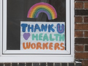 A sign on Marcil Avenue in N.D.G. on Friday April 17, 2020 says thank you to health care workers. "Separating myself from the family was something I needed to do to protect them," nurse Roanne May Tabao writes, but with two young children, this is especially tough.
