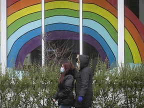 Women wearing masks walks by rainbow on Sherbrooke on Tuesday May 5, 2020. (Pierre Obendrauf / MONTREAL GAZETTE) ORG XMIT: 64307 - 4718