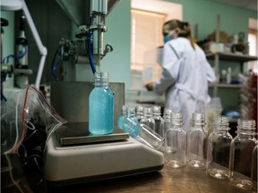 An employee works in the production line of hand sanitizer at a facility of cosmetics company PharmoGel in Novosibirsk on April 29, 2020.