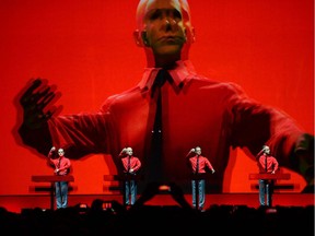 In this file photo taken on January 6, 2015, the piece "Roboter" of the German band Kraftwerk is performed during a concert at the Neue Nationalgalerie (New National Gallery) museum in Berlin. - Kraftwerk co-founder Florian Schneider has passed away a short cancer illness just a few days after his 73rd birthday according to his band co-founder Ralf Hueter on May 6, 2020.