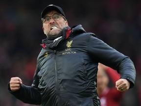 In this file photo taken on March 31, 2019 Liverpool's German manager Jurgen Klopp reacts to their victory on the pitch after the English Premier League football match between Liverpool and Tottenham Hotspur at Anfield in Liverpool