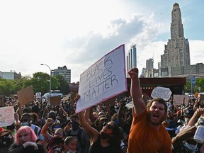 Protesters gather during a "Black Lives Matter" protest near Barclays Center on Friday, May 29, 2020, in the Brooklyn borough of New York City, in outrage after George Floyd, an unarmed black man, died while being arrested by a police officer in Minneapolis who pinned him to the ground with his knee. Demonstrations are being held across the U.S. after Floyd died in police custody on May 25.