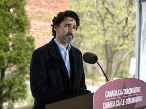 Prime Minister Justin Trudeau listens to a reporter's question during his daily news conference on the COVID-19 pandemic outside his residence at Rideau Cottage in Ottawa, on Saturday, May 9, 2020.