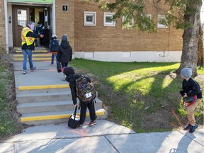Students maintain social distancing at Ecole Marie Rose Monday May 11, 2020 in Saint Sauveur, Que. as elementary schools outside the greater Montreal area reopen.