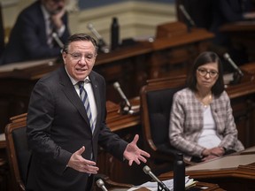 Quebec Premier François Legault responds to the Opposition as the National Assembly resumes with limited attendance of members during the COVID-19 pandemic, Wednesday, May 13, 2020 at the legislature in Quebec City. Quebec Health Minister Danielle McCann, right, looks on.