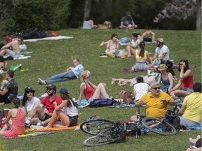 People enjoy the warm weather in a city park in Montreal on Sunday, May 24, 2020.