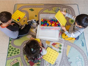 Children play at a daycare in Dollard-des-Ormeaux in 2014: "The public, especially those thrust back to work with limited choice, deserve a plan that does more than reduce the odds of COVID-19," Michael J. MacKenzie and Delphine Collin-Vézina write.