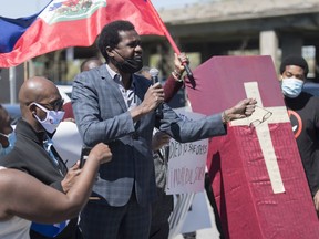 Wilner Cayo, centre, attends a demonstration outside Prime Minister Justin Trudeau's constituency office in Montreal, Saturday, May 23, 2020, where they called on the government to give residency status to migrant workers as the COVID-19 pandemic continues in Canada and around the world.