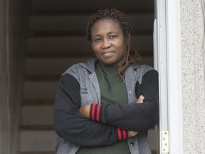 Carole Ze Benedicte, who is originally from Cameroon, poses at the entrance to her apartment in Montreal, Saturday, May 16, 2020.