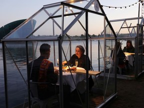 Models and family members are seen dining at a restaurant where they test servers providing drinks and food to models pretending to be clients in a safe "quarantine greenhouses" in which guests can dine in Amsterdam, Netherlands May 5, 2020. Picture taken May 5, 2020. REUTERS/Eva Plevier