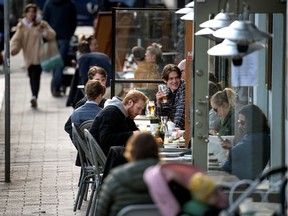 People enjoy themselves at an outdoor restaurant, amid the coronavirus disease (COVID-19) outbreak, in Stockholm, Sweden April 20, 2020. "Sweden tried a more relaxed form of social distancing in an attempt to achieve herd immunity and found itself with a surge in deaths compared to neighbours like Norway and Finland," Christopher Labos writes.