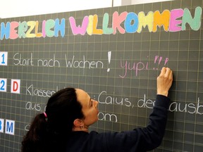 A primary school teacher in Zurich writes words of welcome on the blackboard as students returned May 11, 2020 after Switzerland eased lockdown measures. Montreal educator James Watts says after doing things differently in response to the pandemic, schools should make many of the new practices permanent.