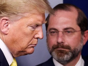 FILE PHOTO: U.S. President Donald Trump walks past Health and Human Services (HHS) Secretary Alex Azar upon arriving to lead the daily Coronavirus-related briefing at the White House in Washington, U.S. March 9, 2020.  REUTERS/Jonathan Ernst/File Photo