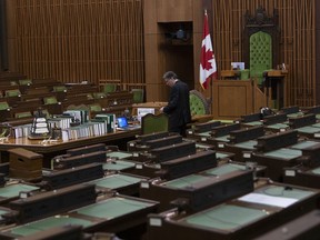 A House of Commons clerk prepares for the COVID-19 committee to meet in the House of Commons Chamber Wednesday April 29, 2020 in Ottawa. Intense behind-the-scenes negotiations are to continue today among federal political parties over how Parliament should function as the COVID-19 crisis drags on. The House of Commons, which has been largely adjourned since mid-March, is to resume normal operations on Monday.