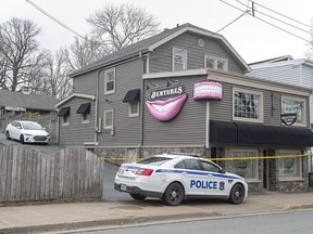 The Atlantic Denture Clinic is guarded by police in Dartmouth, N.S., on April 20, 2020. The repeated threats and isolation a Nova Scotia mass shooter allegedly used against his spouse show why such cruelty should be a criminal offence in Canada, experts on domestic violence say. Acquaintances and former neighbours have described the 51-year-old killer as a clever and manipulative millionaire who would threaten harm to his spouse's family, control her money or cut off her means of escape by removing the tires from her car or blocking the driveway.
