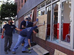 Plywood is placed over broken windows of a CVS store during nationwide unrest following the death in Minneapolis police custody of George Floyd in Manhattan on Sunday, May 31, 2020.