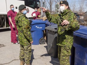 Canadian Armed Forces personnel arrive at the Villa Val des Arbes seniors residence, Monday, April 20, 2020 in Laval, Que. The federal government says 1,350 Canadian Forces soldiers will be deployed to 25 Quebec long-term care homes hard hit by COVID-19 by mid-May.THE CANADIAN PRESS/Ryan Remiorz