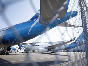 Air Transat aircraft sit on the tarmac at Toronto Pearson International Airport. Canadian airlines’ flight volumes have dropped as much as 95 per cent since March, and Air Canada executives estimate it could take three years to re-establish pre-pandemic flight volumes.