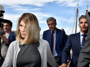 Actress Lori Loughlin and her husband, fashion designer Mossimo Giannulli, leave the federal courthouse after a hearing on charges in a nationwide college admissions cheating scheme in Boston, Massachusetts, U.S., Aug. 27, 2019.