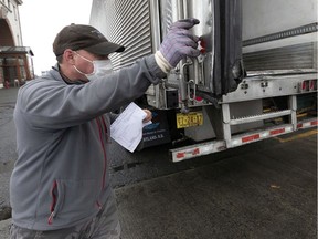 Trucker Tom Dixon, of Beaver River, Nova Scotia, prepares to head back to Canada with a shipment from the Fish Pier, Friday, April 24, 2020, in Boston. "While little was done to make truck drivers' work easier, the supply chain had to continue to function, seamlessly," François Laporte writes.