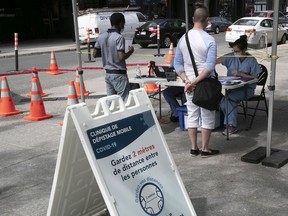 Medical workers process people arriving at a COVID-19 mobile test site in Montreal on May 28.