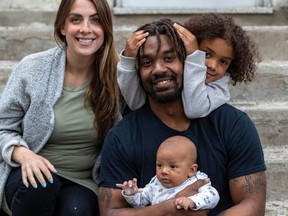 Alouettes running-back Tyrell Sutton poses with his wife, Emilie Desgagné, 6-year-old daughter Kiara Gaudin and 8-week-old son Tyson Sutton at home in Montreal on June 1, 2020.