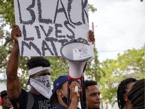 Alouettes running-back James Wilder Jr. holds a Black Lives Matter sign in Houston during a weekend protest.
