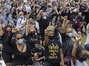 People raise their arms at an event called Montreal Kneels for Change at Loyola park in Montreal Sunday, June 7, 2020. "Without the pause brought upon by COVID-19, this movement would likely not have gathered the momentum that it has," Stephen Cohen says.
