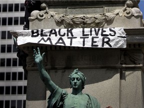 One of many signs seen in downtown Montreal on Sunday, June 7, 200, during march that saw thousands of people decry racism and police brutality.