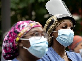 MONTREAL, QUE.: June 9, 2020 --Heath care workers watch a ceremony marking the departure of a group of soldiers leaving the St. Andrew Residential Home, in Montreal, on Tuesday, June 9, 2020. (Allen McInnis / MONTREAL GAZETTE) ORG XMIT: 64559