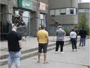 Customers wait in line  at the SQDC store on Acadie Blvd. on Wednesday June 10, 2020.