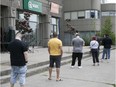 Customers wait in line  at the SQDC store on Acadie Blvd. on Wednesday June 10, 2020.