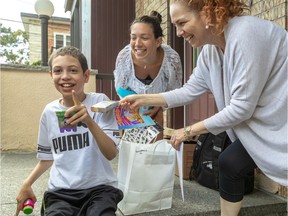 Peter Hall School has sent care packages home to its students. David Anthony Gebran, 11, enjoys his gifts alongside sister Michelle Rachidi and mother Carmen Gomez Gonzales on Thursday June 11, 2020.