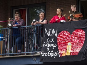 People bang pots as a caravan of Park Extension residents passed by them on Saturday, June 13, 2020. Protesters took to the streets by car and by bicycle  to denounce evictions, and demand additional emergency measures to deal with the housing crisis.