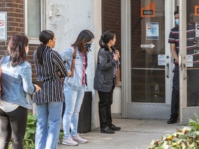 Montrealers line up at the Shadd Business and Health Centre in Montreal June 15, 2020, on the first day of training to become orderlies.