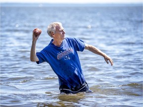 Dave Boys stands in Lac St-Louis in Pointe Claire, west of  Montreal while playing catch with his daughter  Wednesday June 17, 2020. (John Mahoney / MONTREAL GAZETTE)