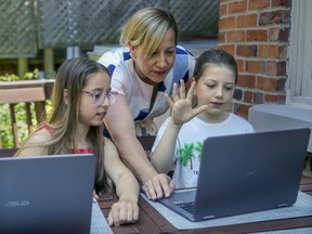 Caroline Phaneuf, chairperson of the English Montreal School Board's parents' committee, with her daughters Sophia, left, and Maya are seen at their home in Montreal West on Tuesday June 16, 2020.