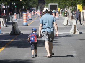 A father and son walk along Mont-Royal Ave. near De Lorimier Ave. on June 17, 2020.