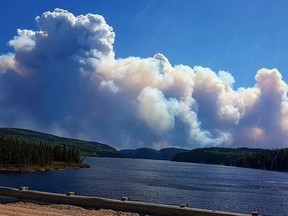 A massive forest fire burning north of Lac-Saint-Jean throws up a wall of smoke visible for kilometres on Thursday,